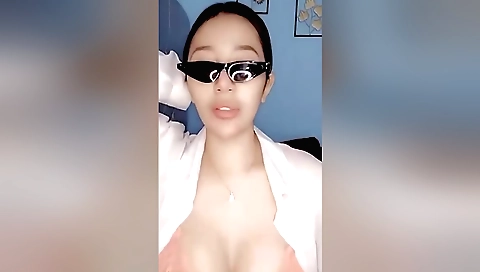 A very sexy brunette shows off her body with a bikini