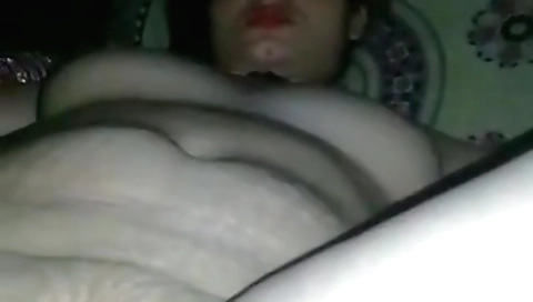 Indian brunette is naked and wearing a white dress